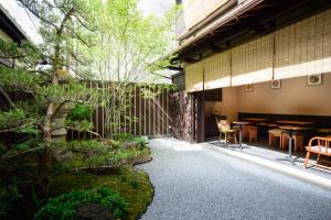 a japanese garden with a table and a tree at Luck You Kyoto in Kyoto