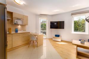 Televízia a/alebo spoločenská miestnosť v ubytovaní Morskie Oko V by Noclegi Renters