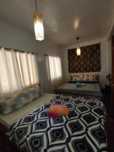 Postel nebo postele na pokoji v ubytování Purple Homestay Hillside