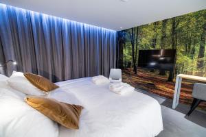 Postel nebo postele na pokoji v ubytování L'Ardenne Autrement Wellness include