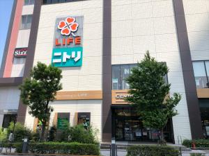 a building with a sign on the side of it at COTO Tokyo Asakusa 5 in Tokyo