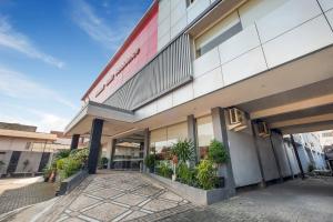 a store front of a building with plants outside at OYO Flagship 3726 Tembok Batu Residence in Yogyakarta