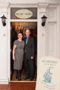 a man and a woman standing in a doorway at Seahorse Guest House in Great Yarmouth