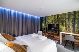 Postel nebo postele na pokoji v ubytování L'Ardenne Autrement Wellness include