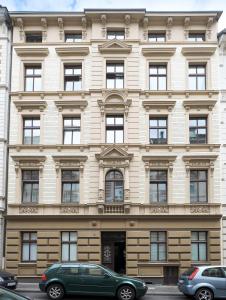 a building with cars parked in front of it at *80 m2 Stylish Apt* Netflix * Kitchen* Nespresso* in Wuppertal