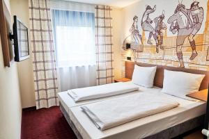 Postel nebo postele na pokoji v ubytování McDreams Hotel München - Messe