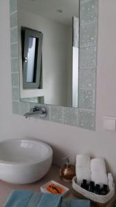 a white bathroom with a sink and a mirror at Villa Lilium in Athanion