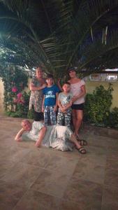 a group of people standing in a room at Orange House Guest House in Adler