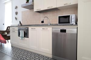 A kitchen or kitchenette at Luisella Apartments