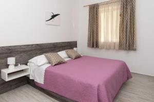 Кровать или кровати в номере Apartments Lovrić