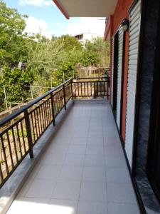 a balcony of a house with a walkway at Deaspoina Apartments in Nea Roda