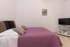 Кровать или кровати в номере Apartments Lovrić
