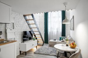 a kitchen and living room with a spiral stair at NEW KK 39 Old Town in Lublin