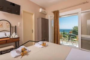 a bedroom with a bed and a view of the ocean at Dimitreli Eleni Studios in Koinyra