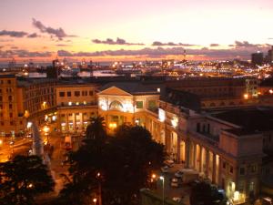 a view of a city at night with lights at Hotel Bellevue in Genoa