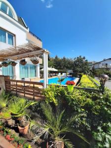 a house with a swimming pool and plants at Milennia Family Hotel in Sunny Beach