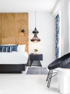 a living room with a couch, chair and a lamp at Kimpton Angler’s Hotel South Beach, an IHG Hotel in Miami Beach