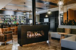 a fireplace in the lobby of a restaurant at Radisson Hotel Szklarska Poręba in Szklarska Poręba