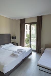 מיטה או מיטות בחדר ב-Hotel Real Balneario Carlos III
