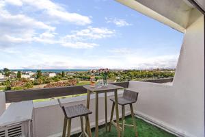 a table and chairs on a balcony with a view at Cap d'Agde Studio - Village naturiste in Cap d'Agde