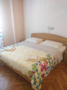 a bedroom with a bed with two towels on it at Guest House Silvia in Rab