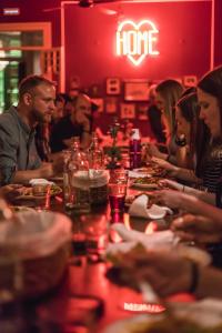 a group of people sitting at a table in a restaurant at Home Lisbon Hostel in Lisbon