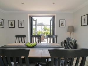 a dining room table with a bowl of fruit on it at Garth End in Kirkby Thore