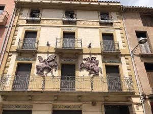 a building with statues on the side of it at Apartaments Cal Noi in Camprodon