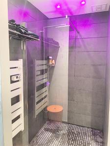 a bathroom with a shower with purple lighting at LE DONJON Villa BDSM Port Nature VILLAGE Cap d'Agde naturiste in Cap d'Agde