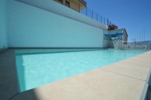 a swimming pool at a hotel with blue sky at case vacanze piccolo in Balestrate