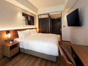 Mercure Ambassador Seoul Hongdae客房内的一张或多张床位
