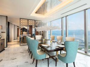 una sala da pranzo con tavolo e sedie di Raffles Shenzhen, Enjoy the daily happy hour in Long Bar, complimentary mini bar and welcome amenities a Shenzhen