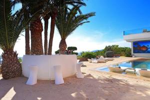 a resort with palm trees and a swimming pool at Mirage Ibiza in Ibiza Town