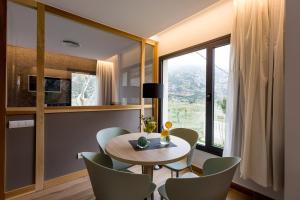 comedor con mesa, sillas y ventana en Sant Pere Homes en Ballestar