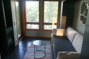 a living room with a couch and a table at Villa Tammio in Uusikaupunki