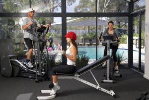 a group of people exercising on exercise bikes in a gym at Leeuwin Apartments in Margaret River Town