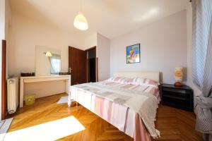 a bedroom with a bed and a desk in it at Giorgio - Fontana in Zadar