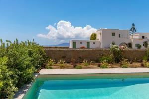 a swimming pool in front of a house at Salinus Villas in Plaka