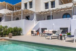 a villa with a swimming pool and a house at Salinus Villas in Plaka