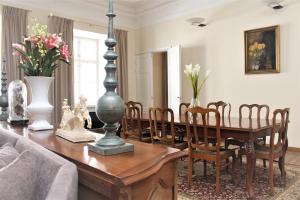 a living room with a wooden table and a dining room at Tallinn City Apartments Old Town Toompea in Tallinn