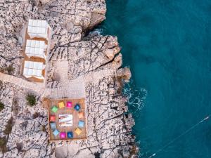 an aerial view of a resort on a cliff next to the water at Lycia Hotel in Kaş