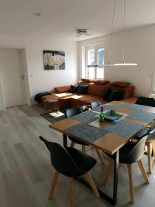 a living room with a table and chairs and a couch at Inselhof Usedom in Usedom Town