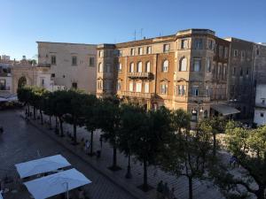 a street in a city with buildings and trees at B&B San Martino in Martina Franca