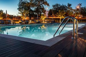 a swimming pool with a metal stairway leading into it at Luna Arcos Hotel Nature & Wellness in Arcos de Valdevez