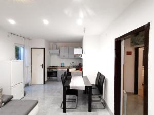 a kitchen and dining room with a table and chairs at Apartment Plese in Baška