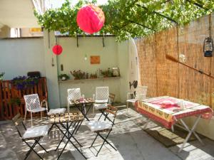 a patio with chairs and a bed and a table at B&Bvintage5bis in Turin