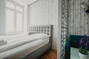 Łóżko lub łóżka w pokoju w obiekcie ZEUS Design Apartments Wasserwelt