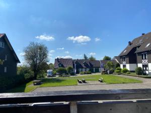 a park with benches in a village with houses at Ferienwohnung Fichtenweg in Winterberg