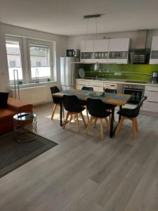 a kitchen with a table and chairs in a room at Inselhof Usedom in Usedom Town