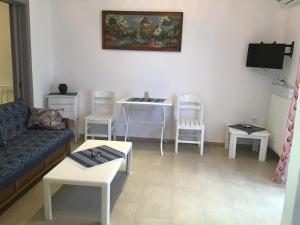 a living room with a couch and a table and chairs at Villa Maria in Kamariotissa